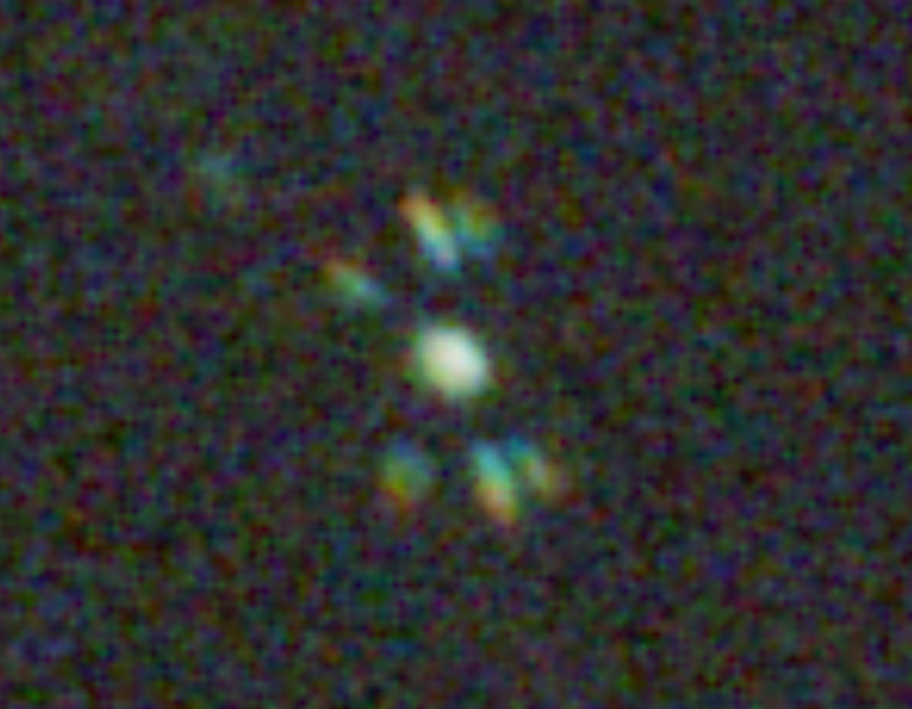 A star's Bahtinov diffraction spikes on a live-view screen, still spread out — out of focus