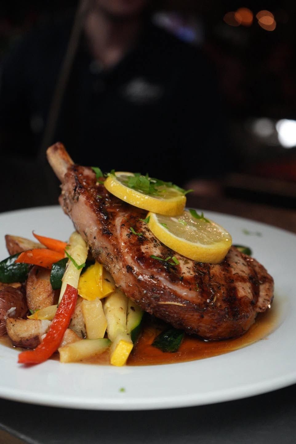 Grilled bone-in chop with lemon and roasted vegetables