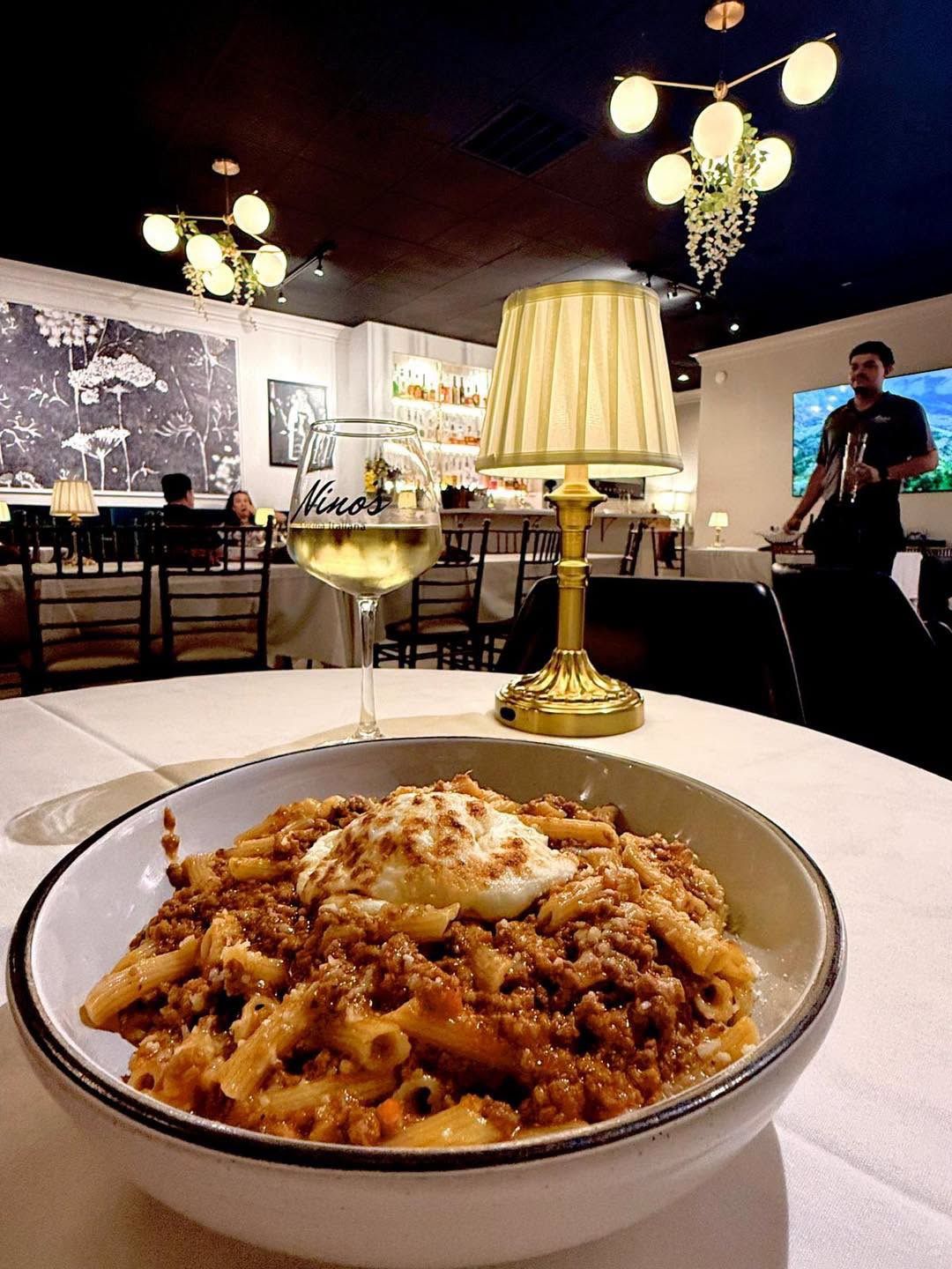 Pasta with meat ragù and ricotta in the dining room