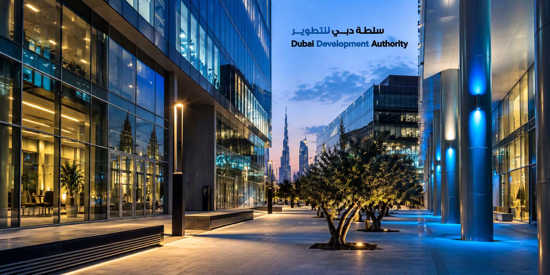 Modern Dubai business district at dusk with Dubai Development Authority lettering