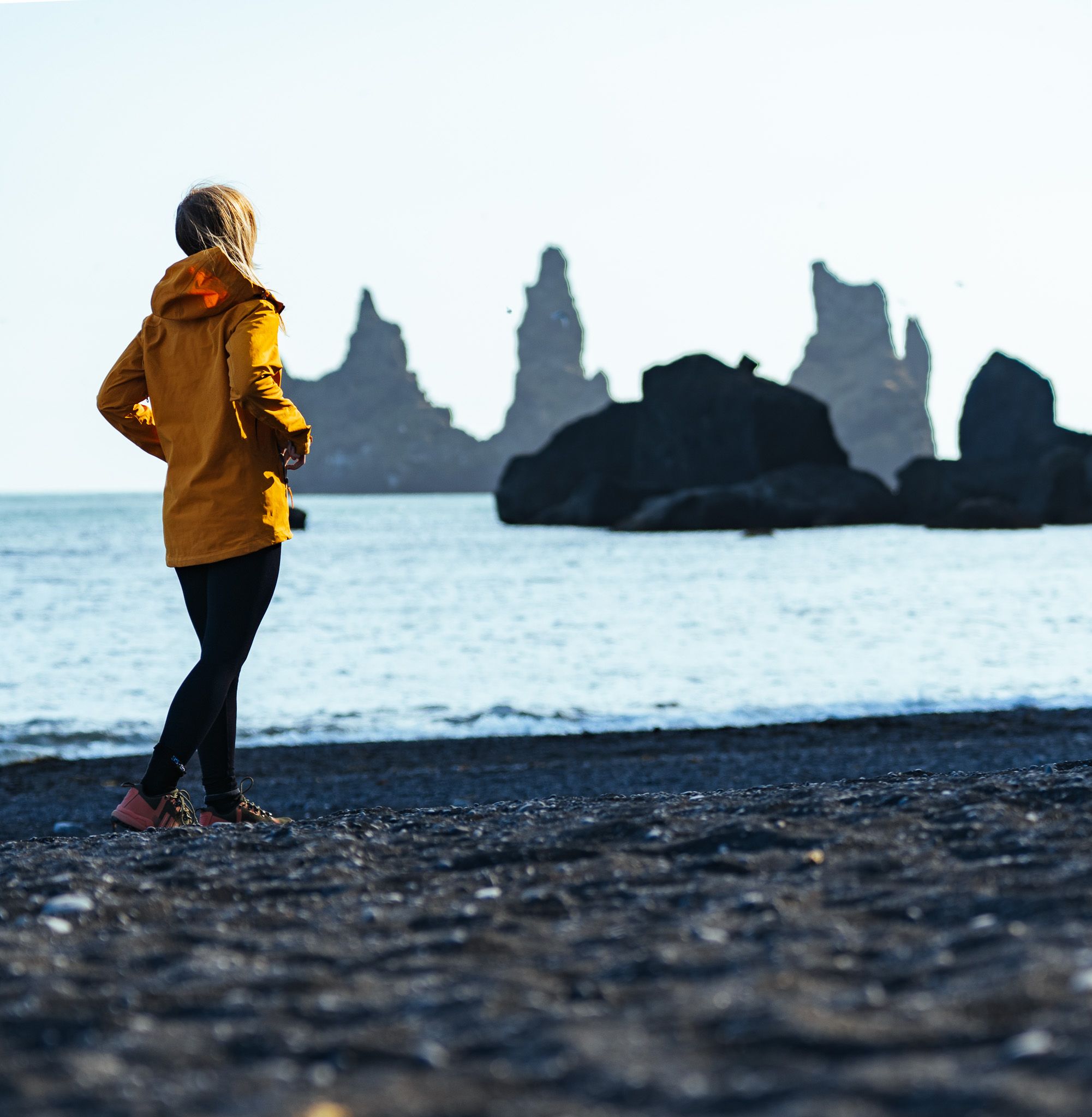 standing on a black sand beach in iceland