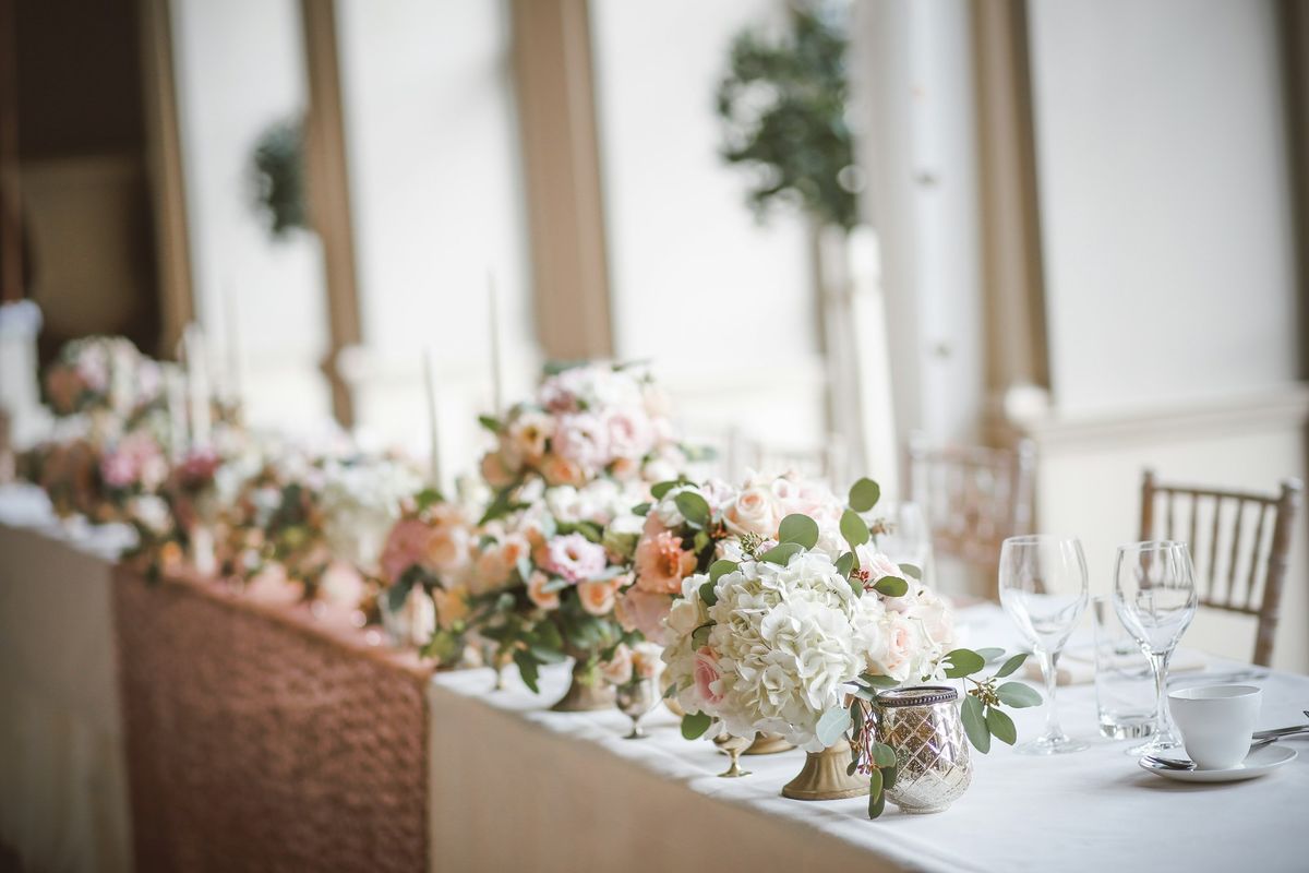 Floral decorations on the top table at a wedding