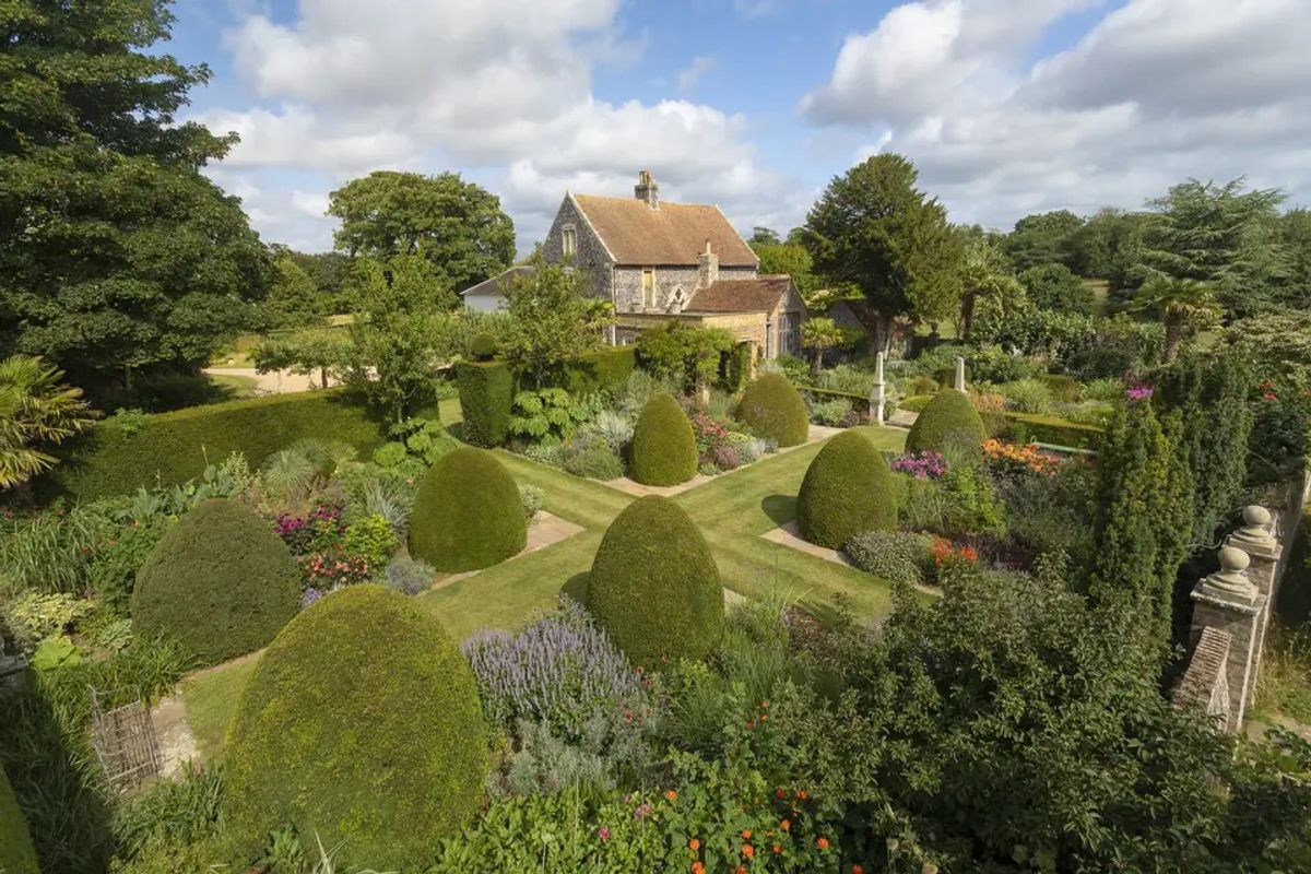 Aerial view of Chapel House Estate's manor house and formal topiary garden