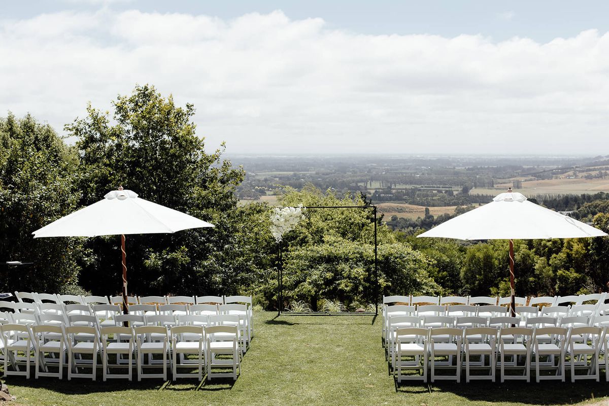 Outdoor ceremony seating overlooking rolling countryside at Waipuna Estate