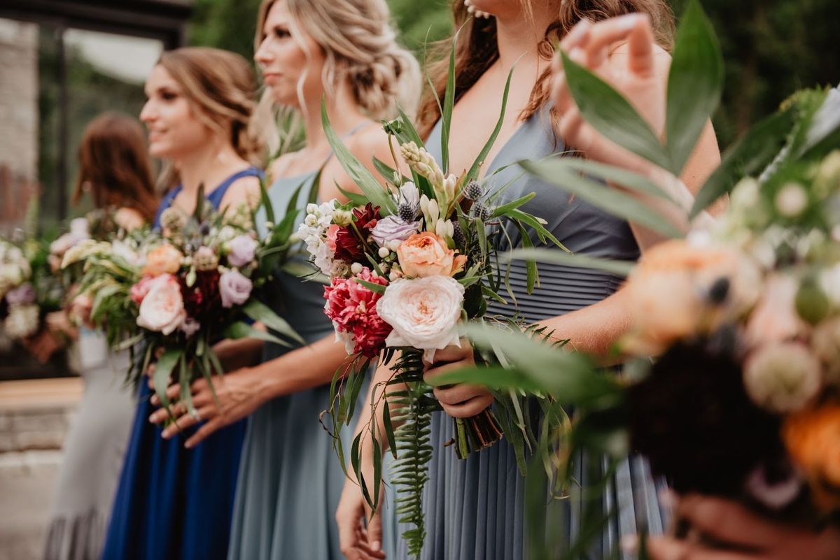Bridesmaids holding bouquets of flowers