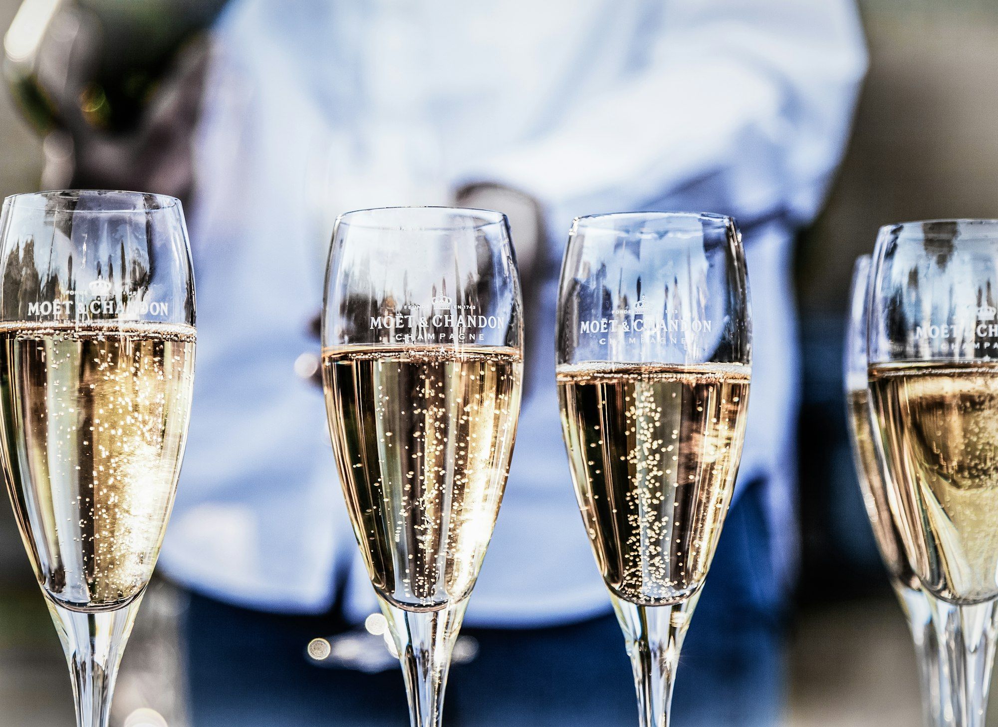Row of champagne flutes filled and ready for a toast