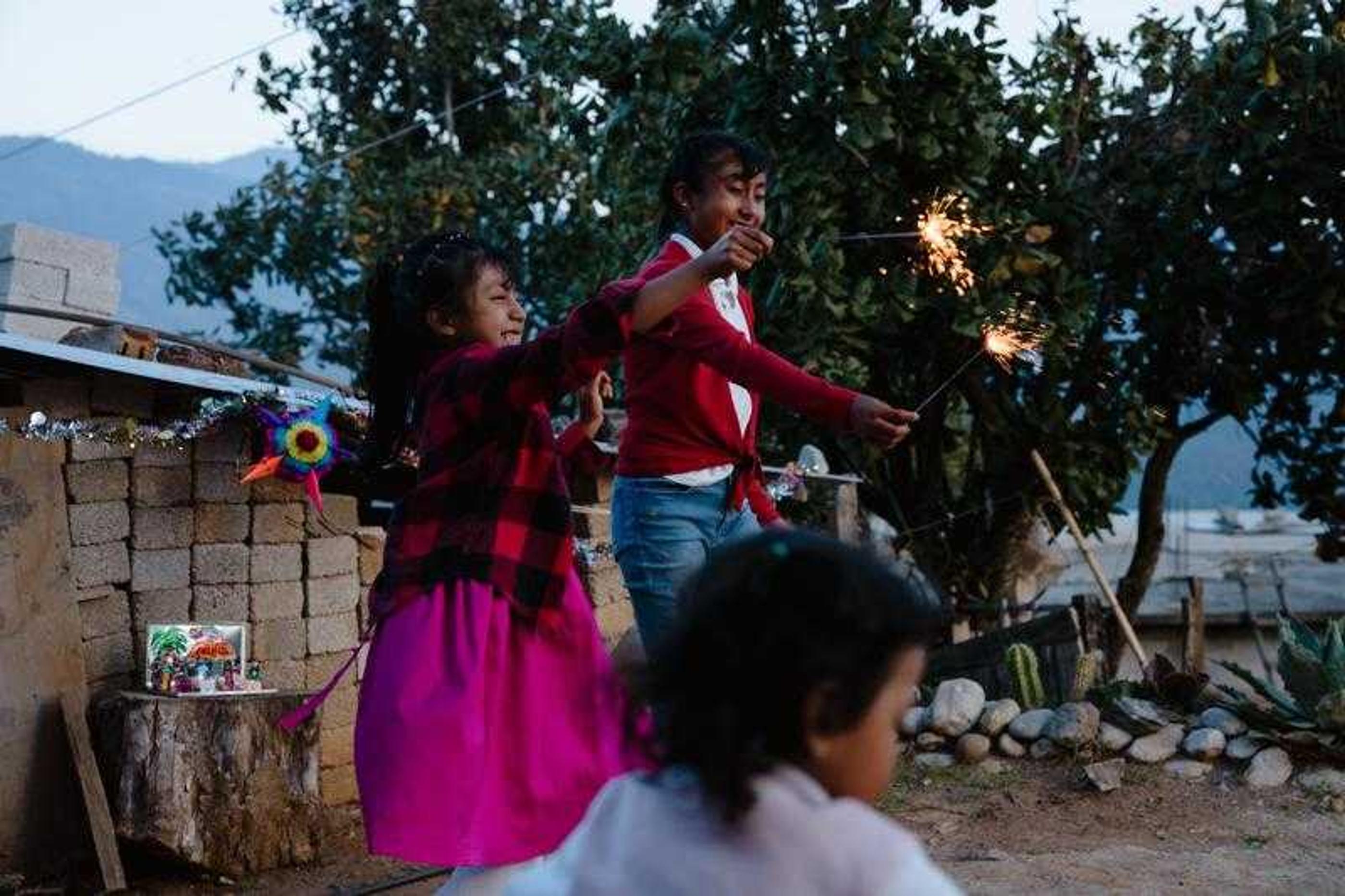 Alicia playing with other children and sparklers