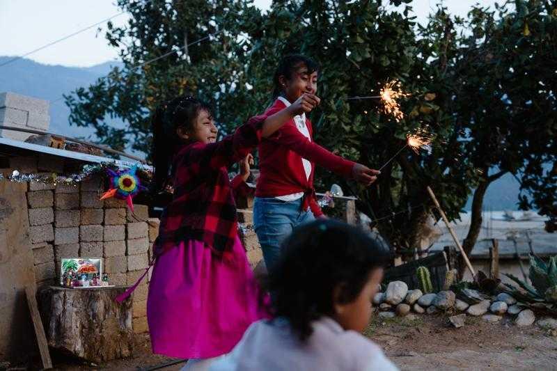 Alicia playing with other children and sparklers