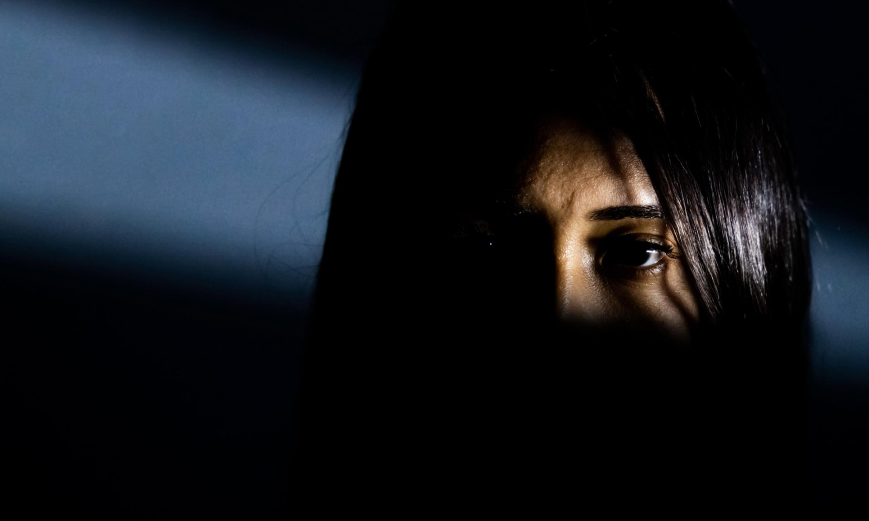 Women shrouded in shadow