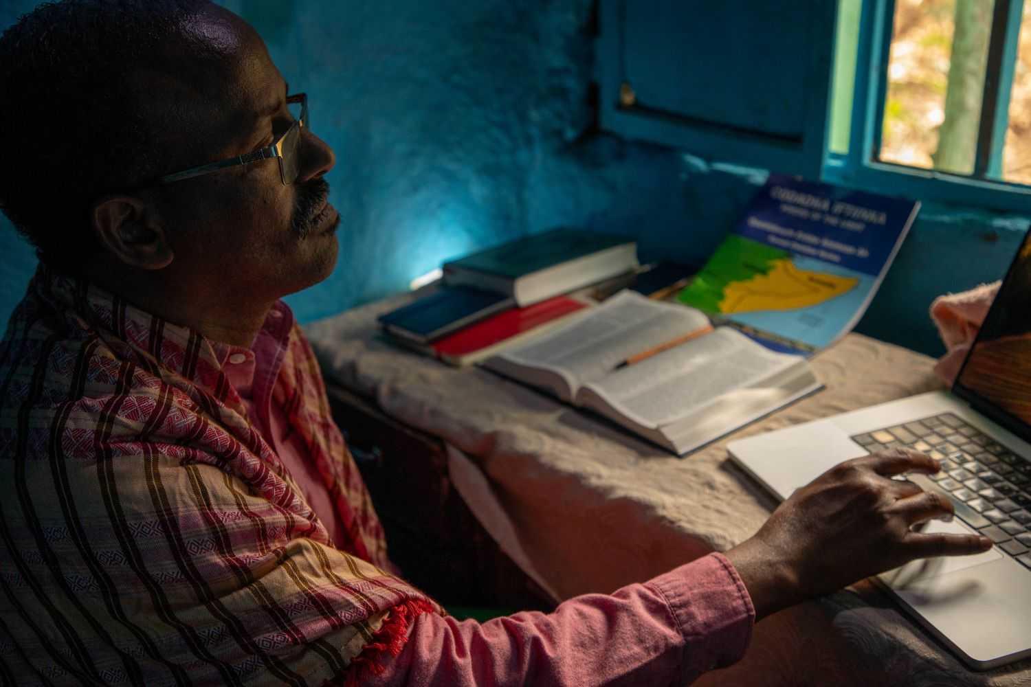 Aweis working at his desk