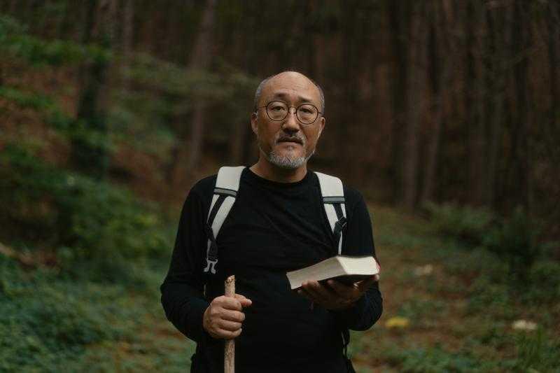 Cho walking with his Bible