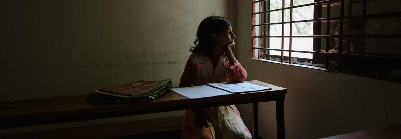 A girl in Bangladesh looking out the window at school