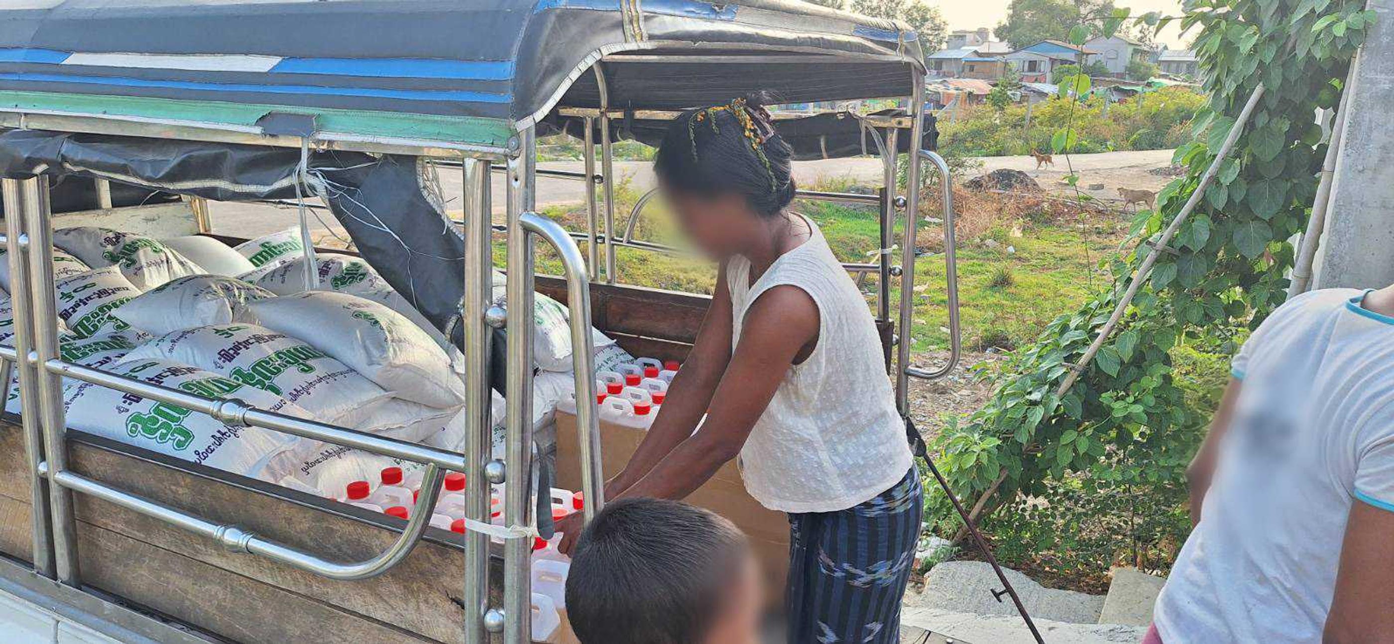 Believers loading the vehicle with groceries and preparing for distribution 