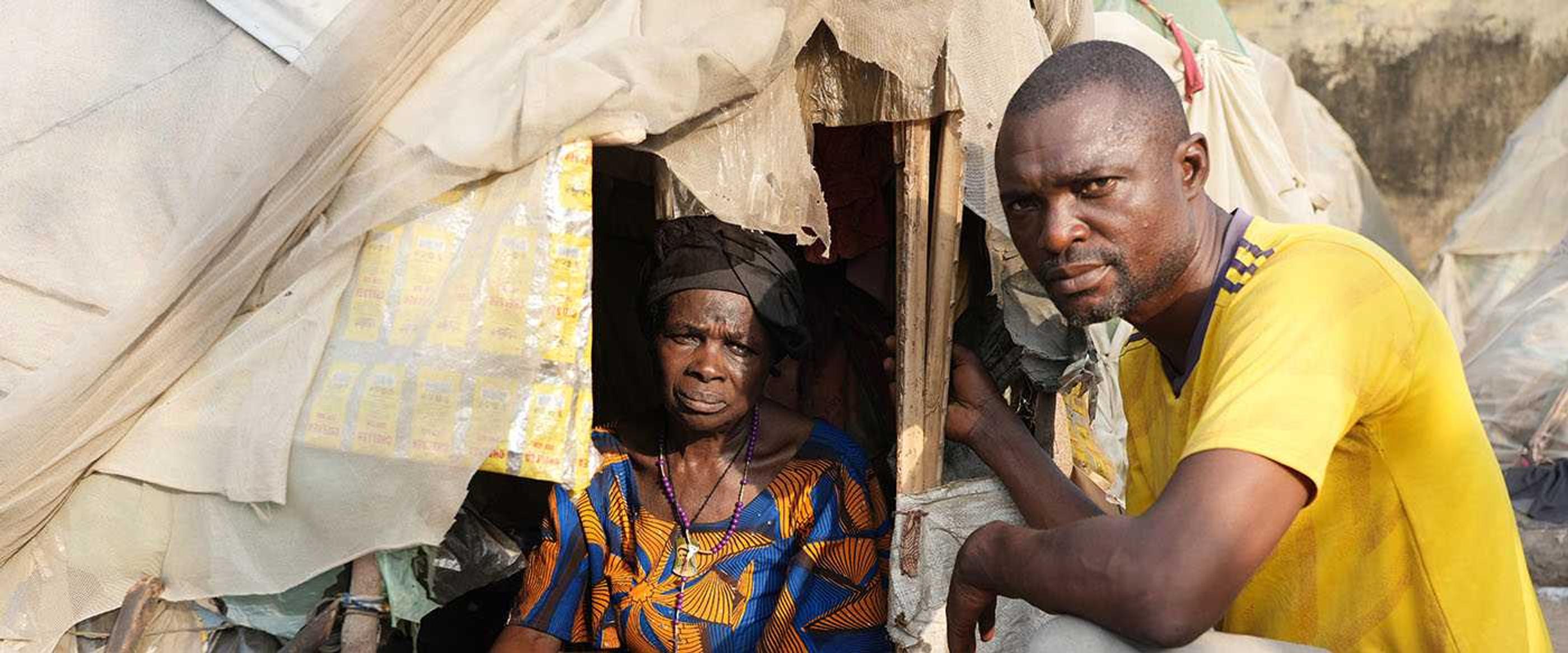 Pastor Barnabas and a displaced woman in an IDP camp in Nigeria
