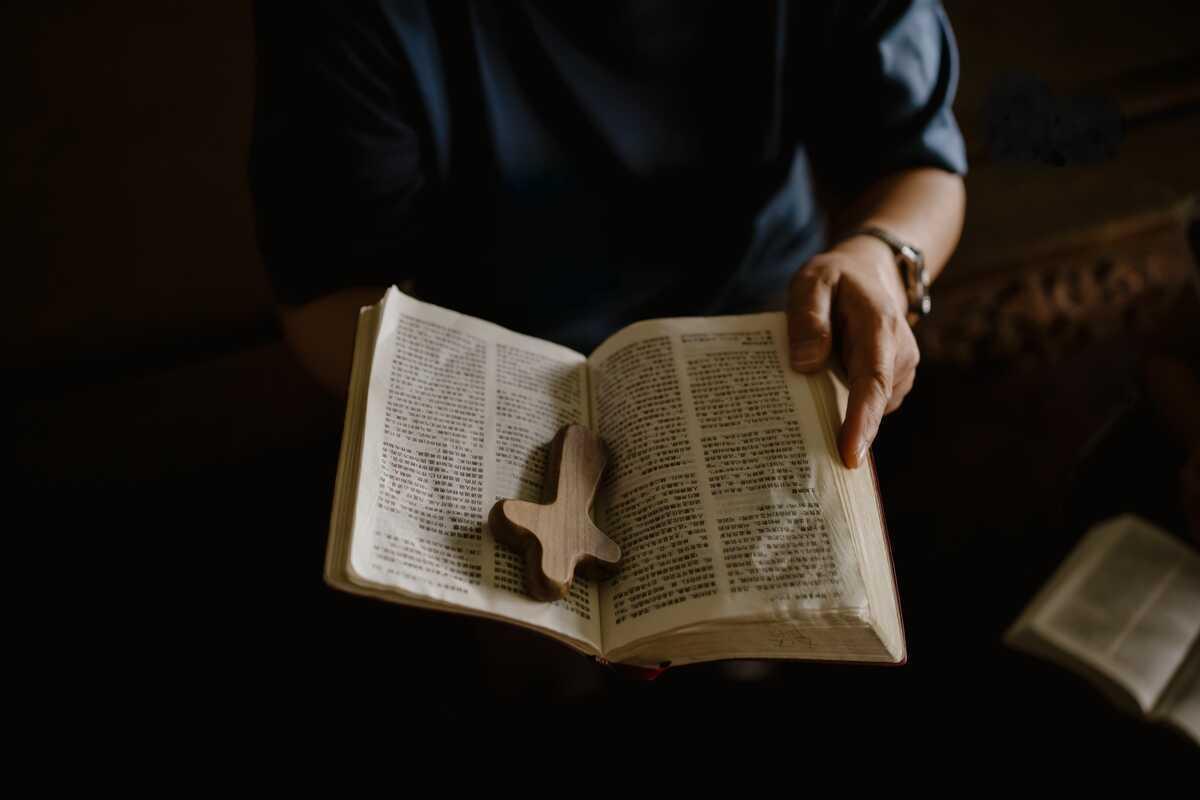 Jinyi holding a Bible and cross