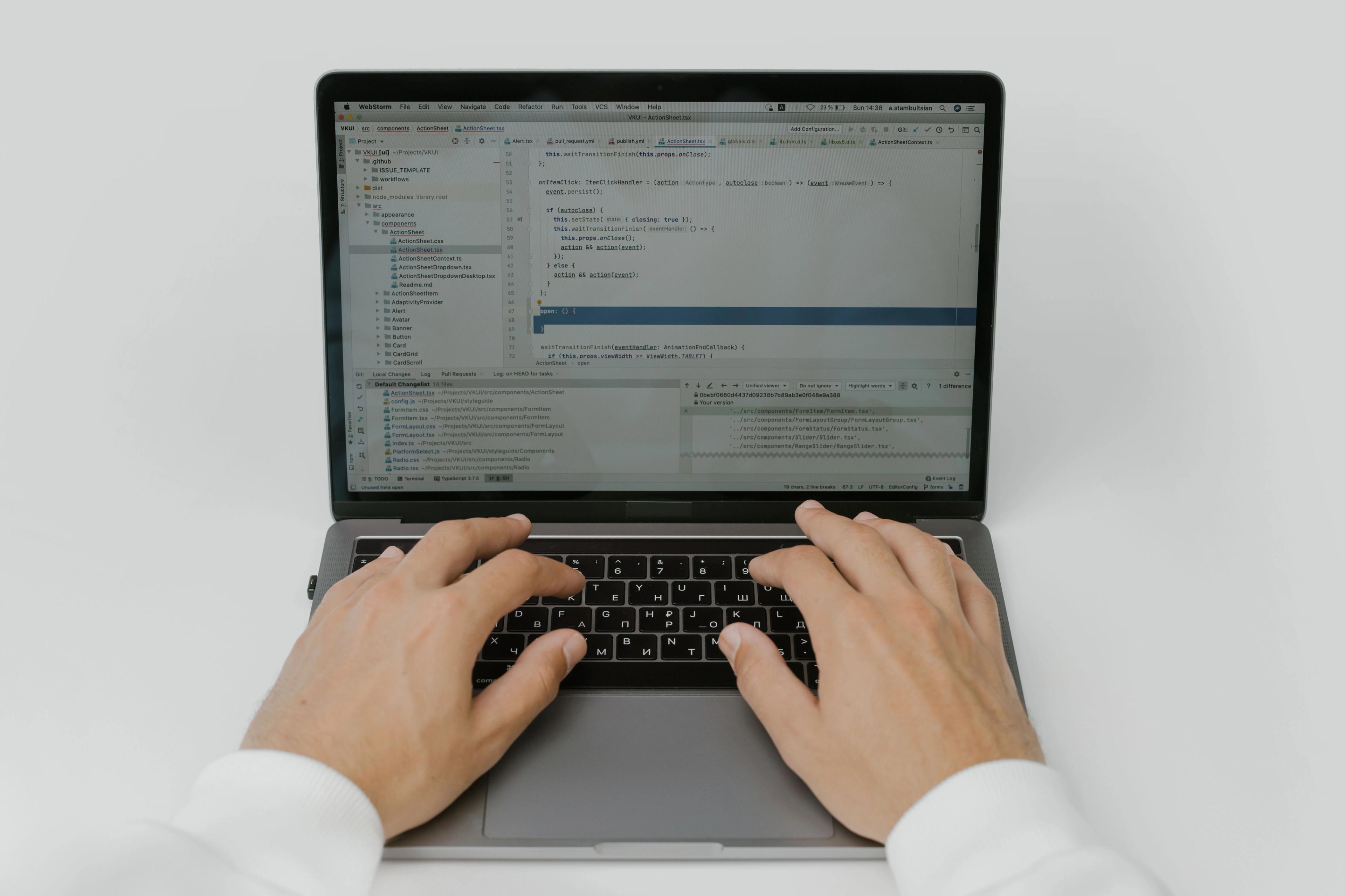 Close-up of hands coding on a laptop, showcasing software development in action.