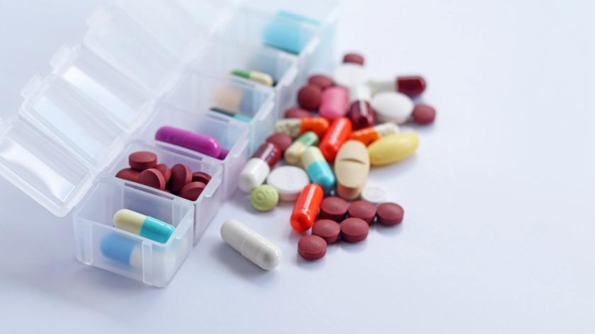 Pills in and around pill organizer container