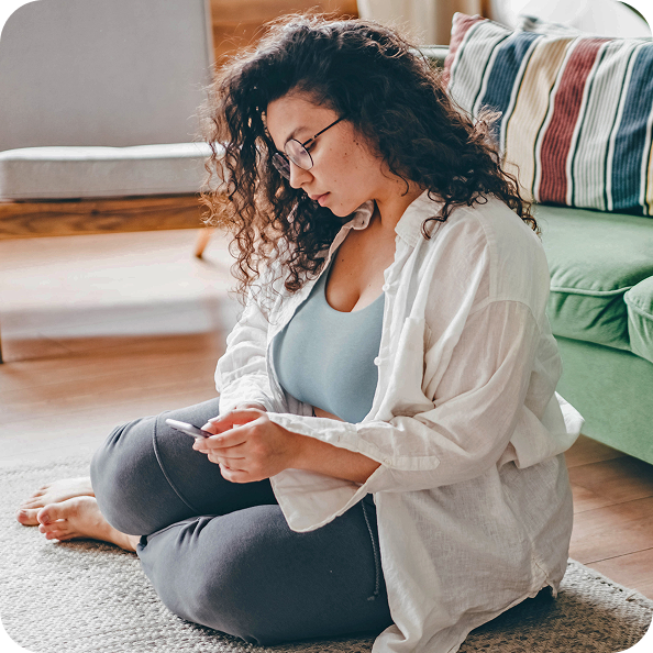 Woman sitting looking at phone