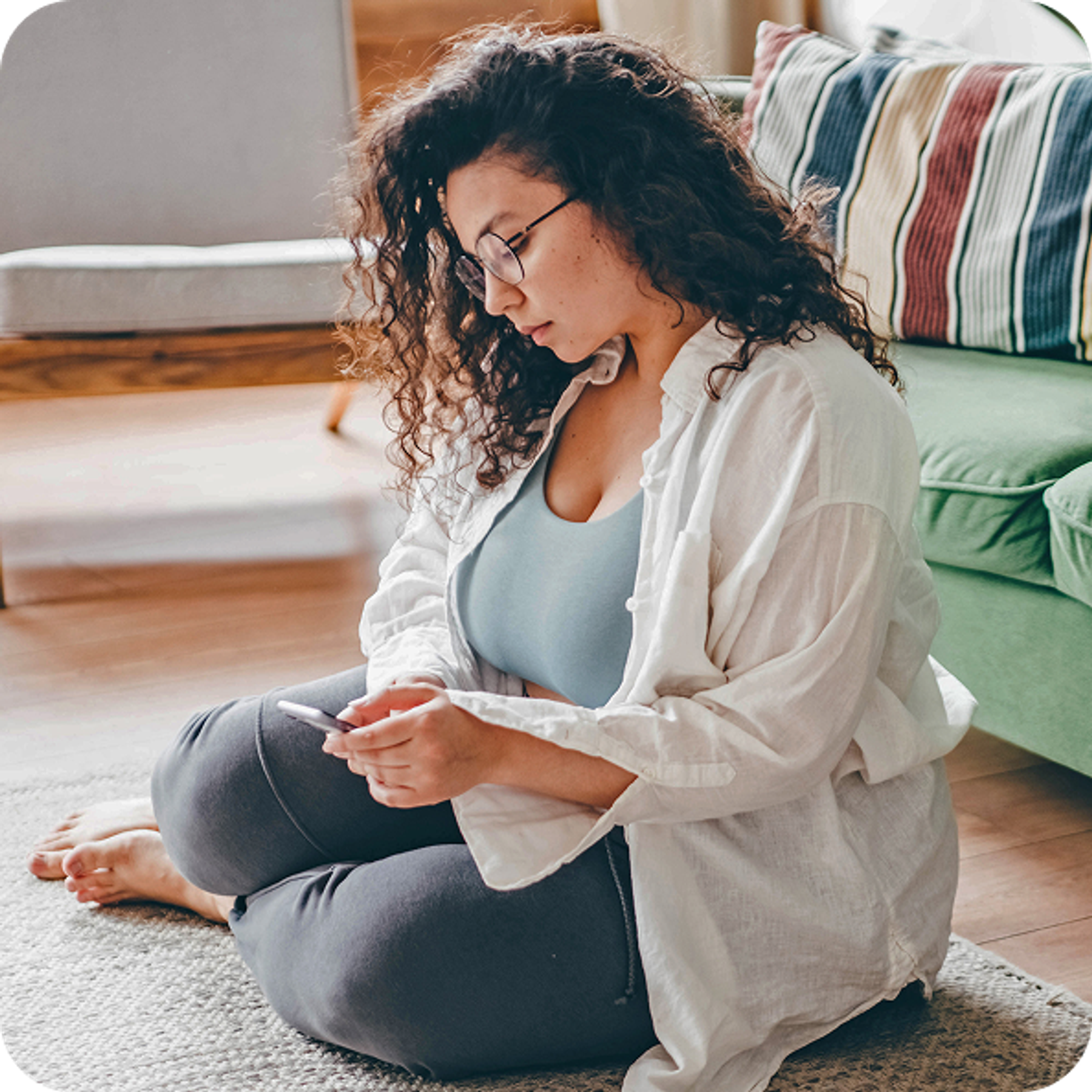 Woman sitting looking at phone