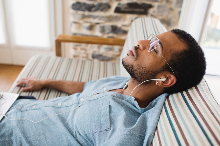 Guy resting on couch.