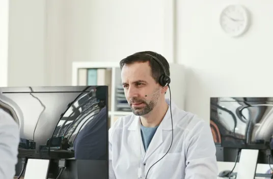 Male doctor working in front of computer