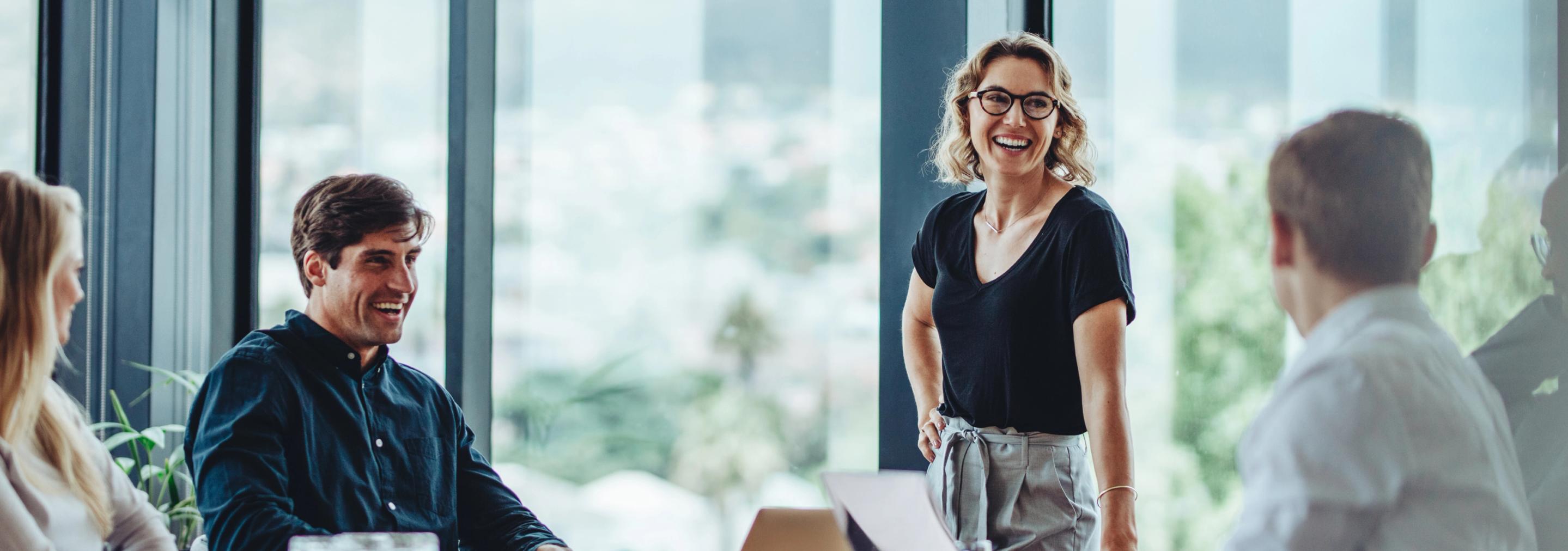 group of people laughing in a meeting