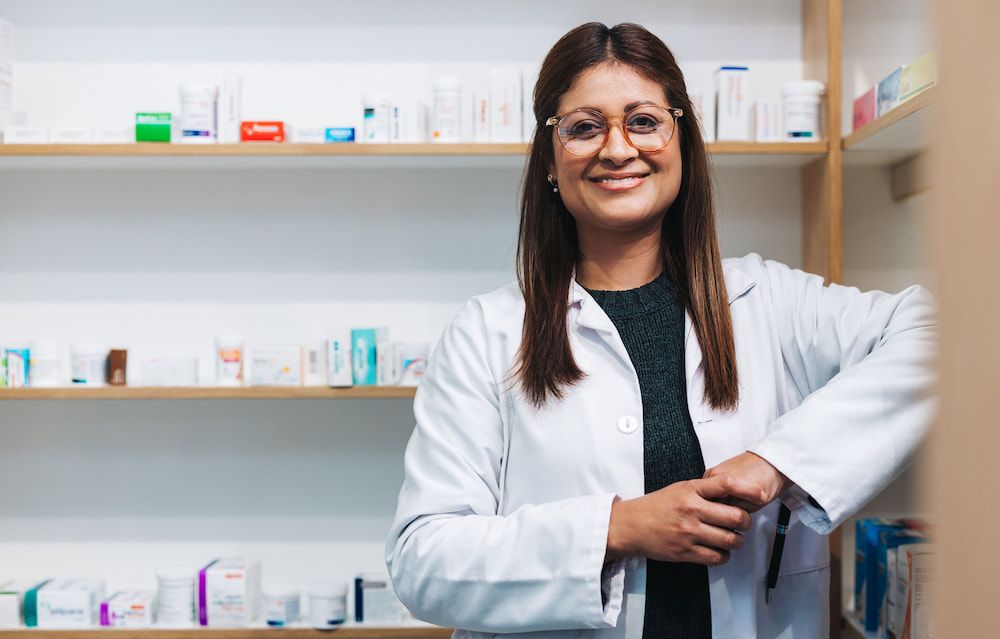 Female pharmacist smiling in pharmacy