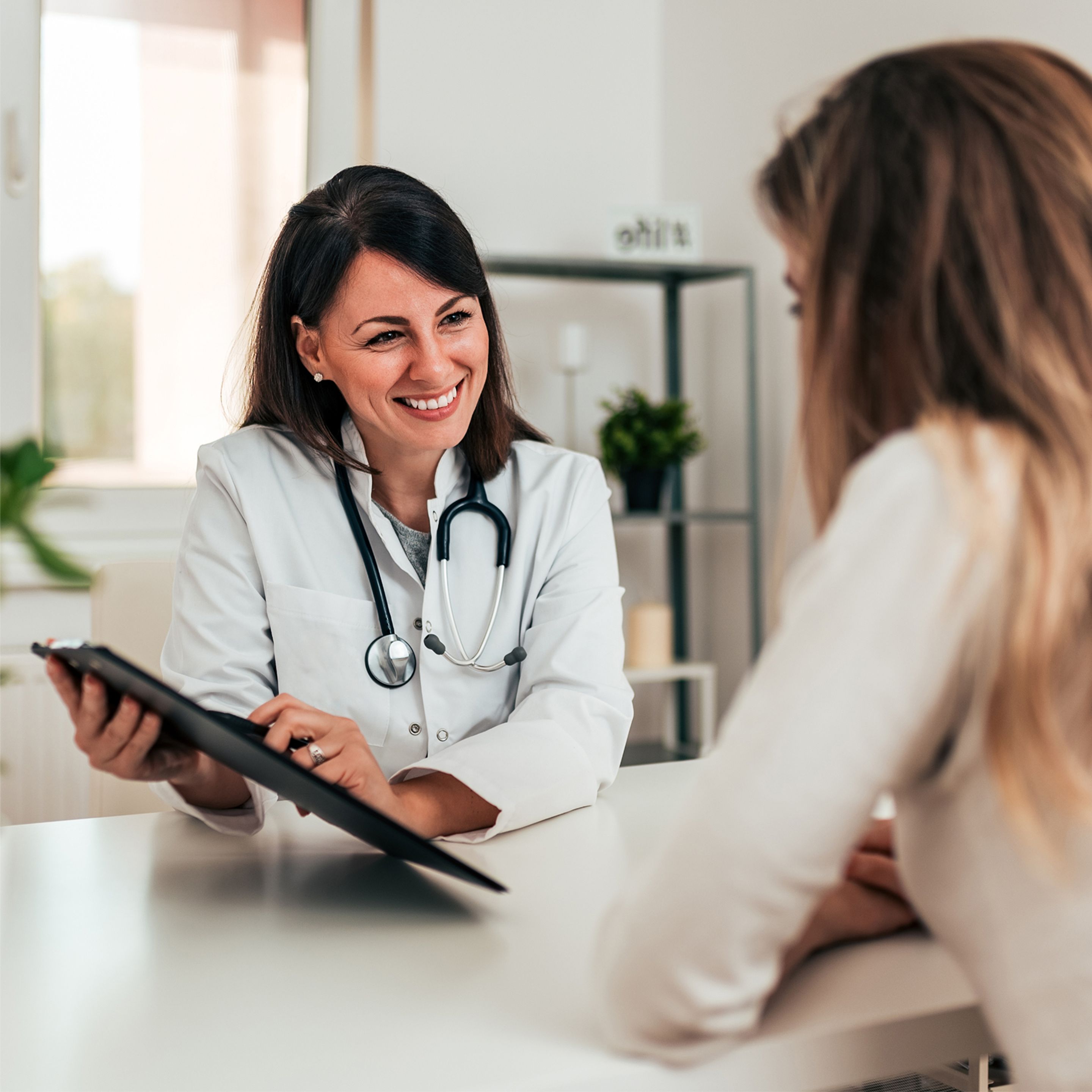 Medical professional showing patient information on a tablet