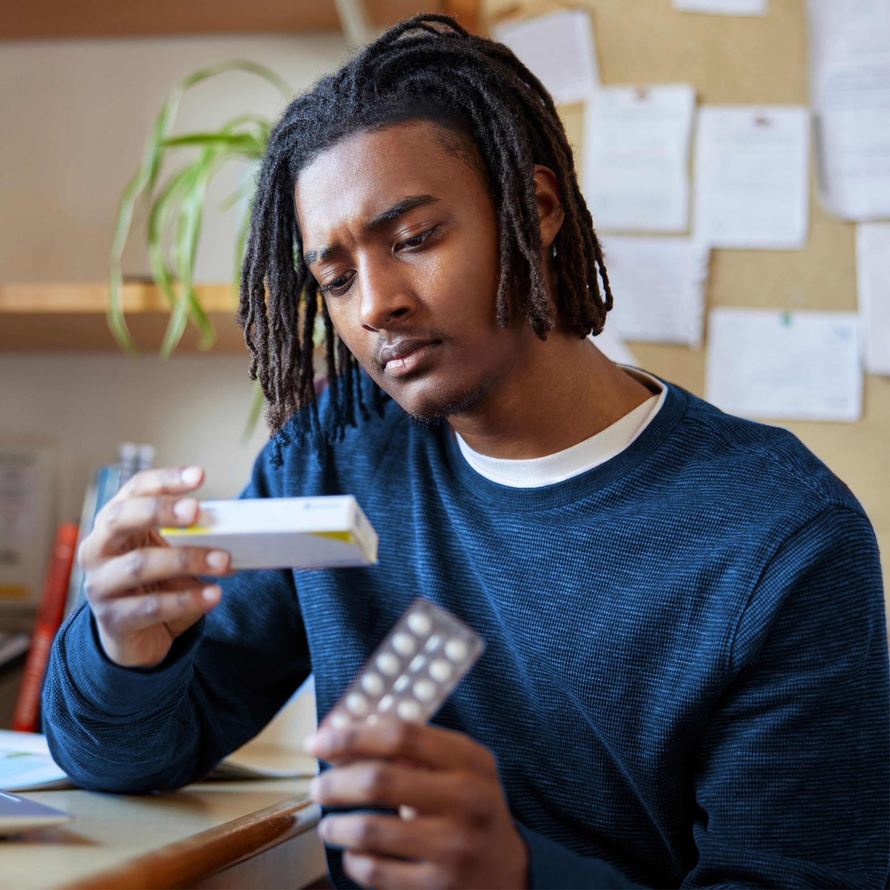 man looking at pills
