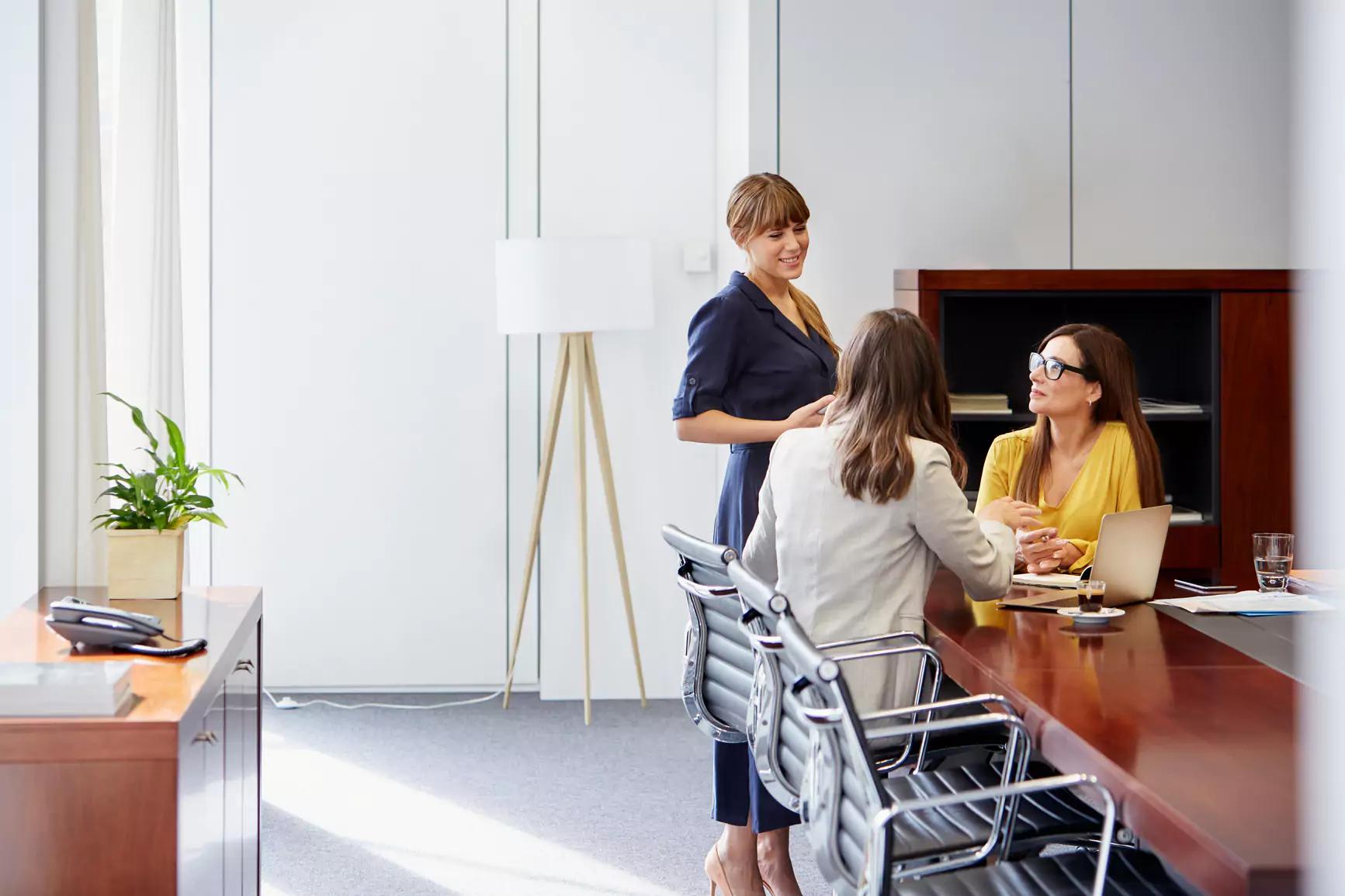 A group of coworkers having a conversation in the office