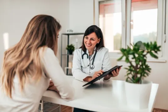 female healthcare working smiling at computer
