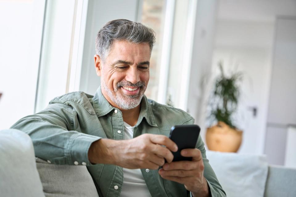 Man smiling at smartphone