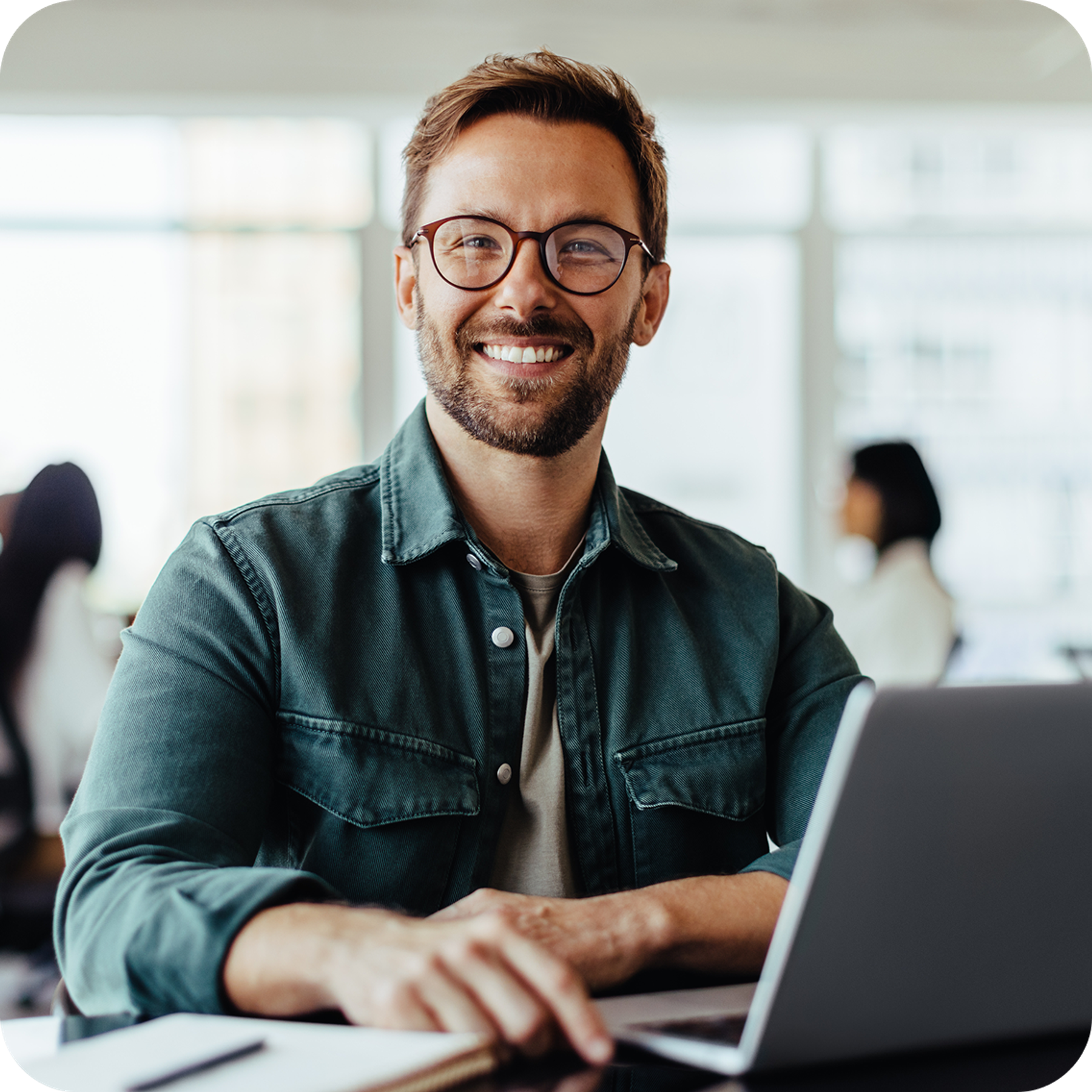 Smiling man using laptop