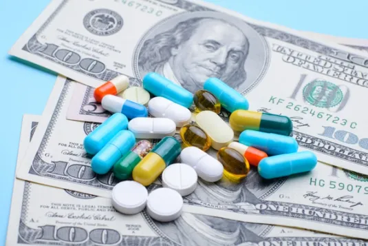 money with a variet pill on top