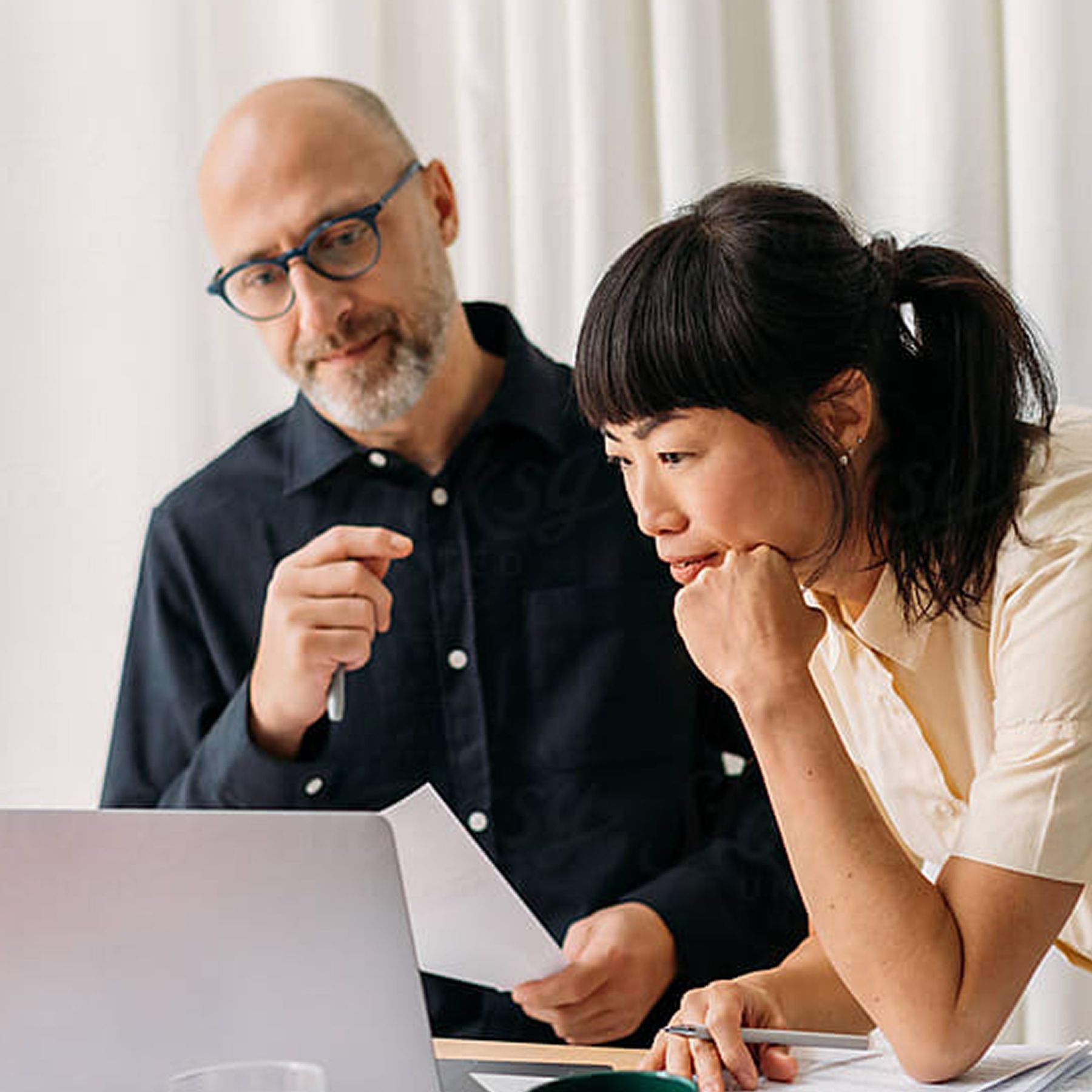 mand and lady looking at laptop