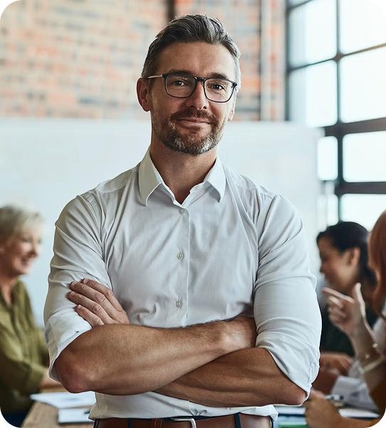 Man smiling with arms crossed