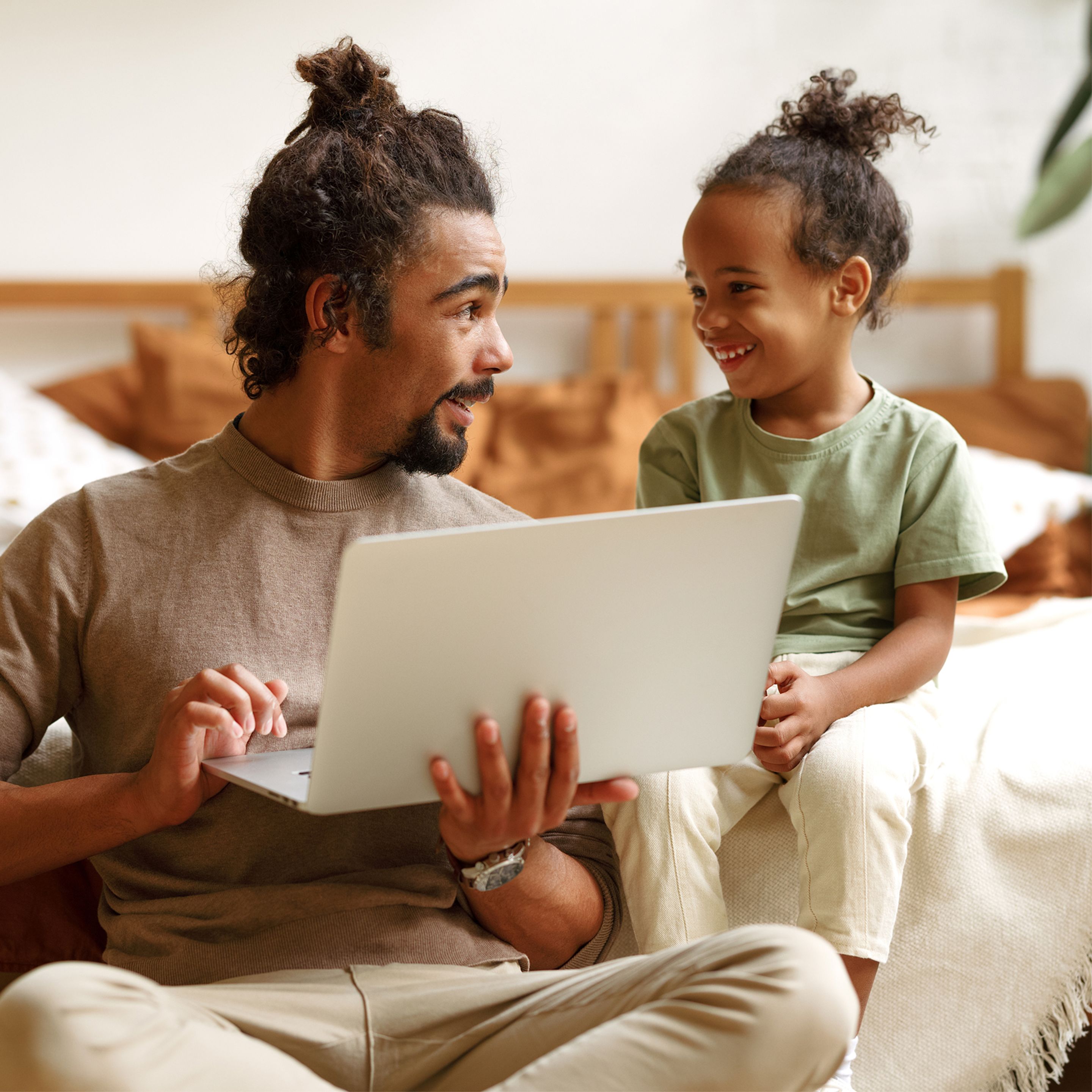 man and child looking at screen