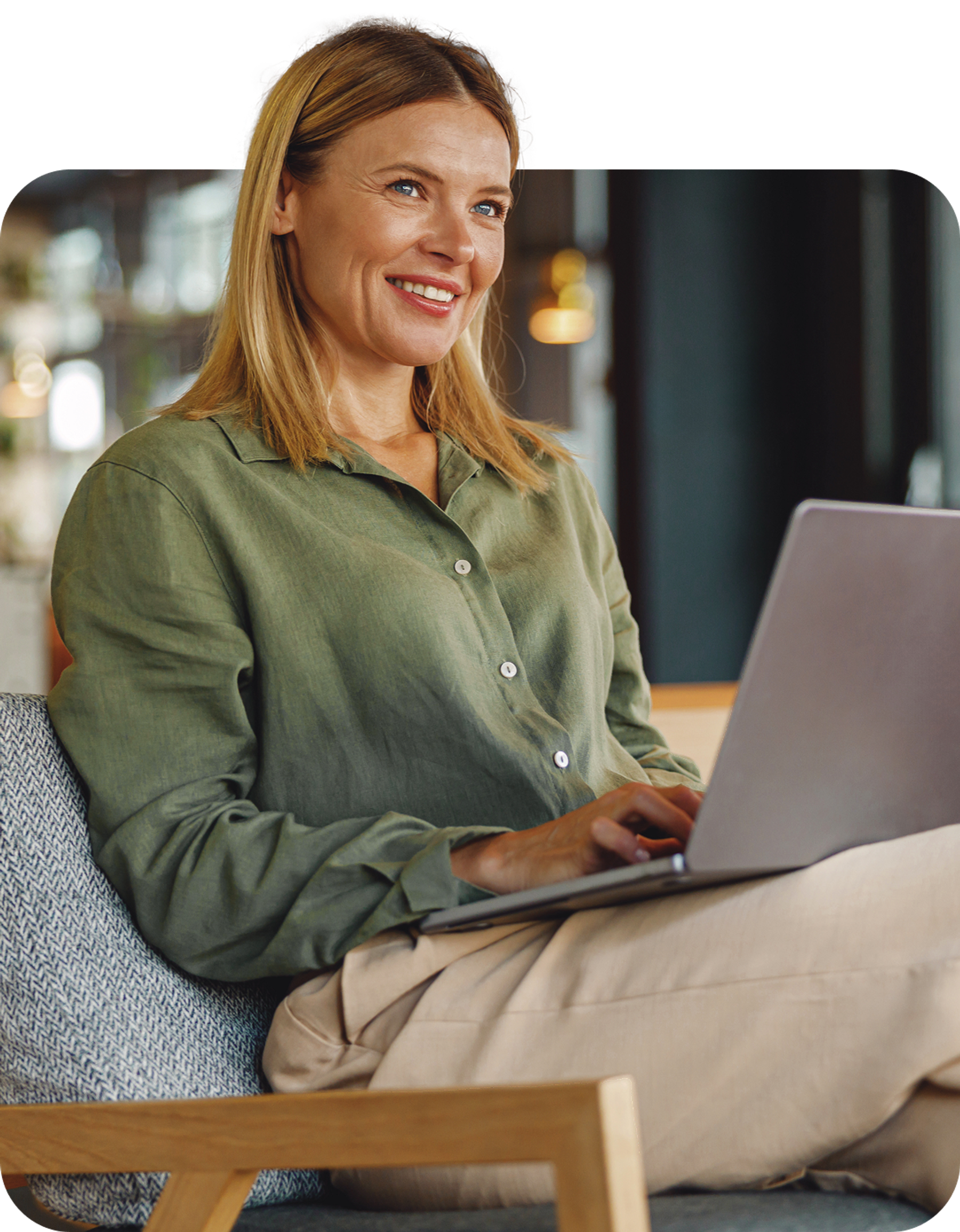 Woman sitting and smiling on laptop