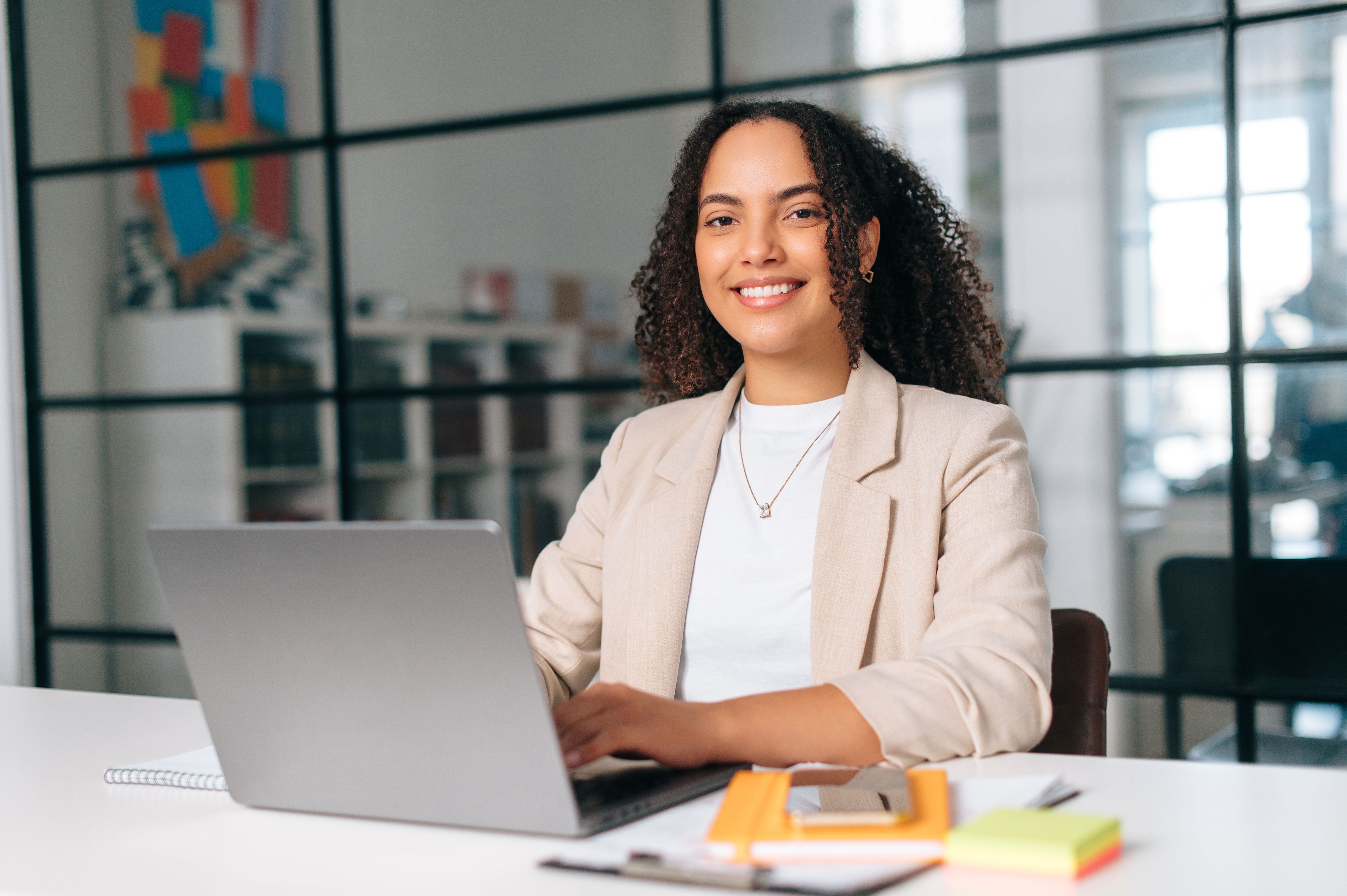 Woman sitting at laptop smiling