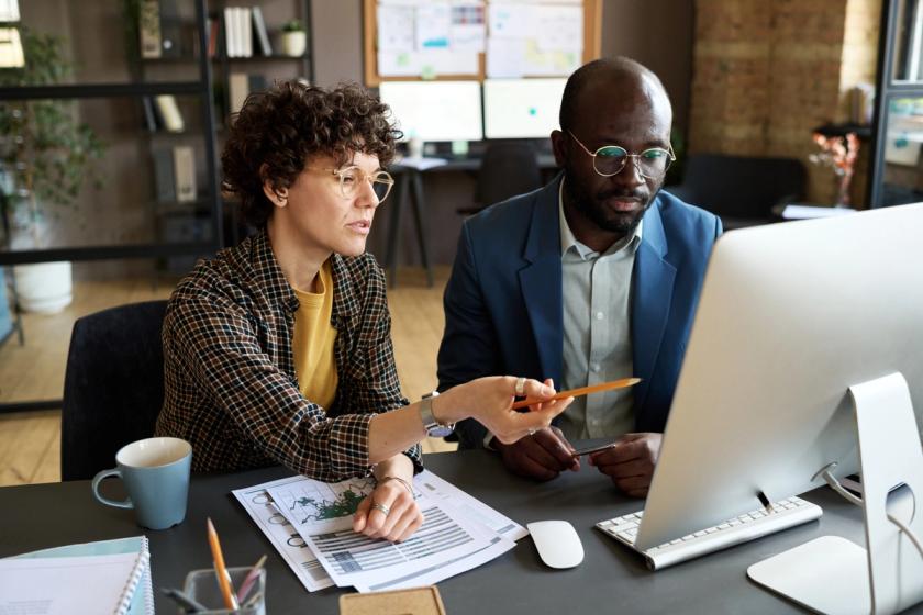 Business People Discussing Presentation on Computer.