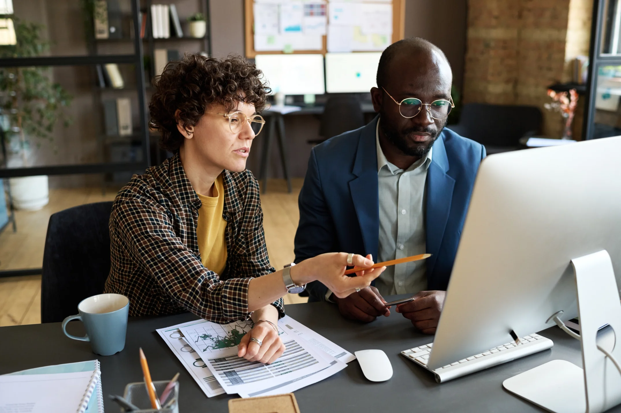 Business People Discussing Presentation on Computer.