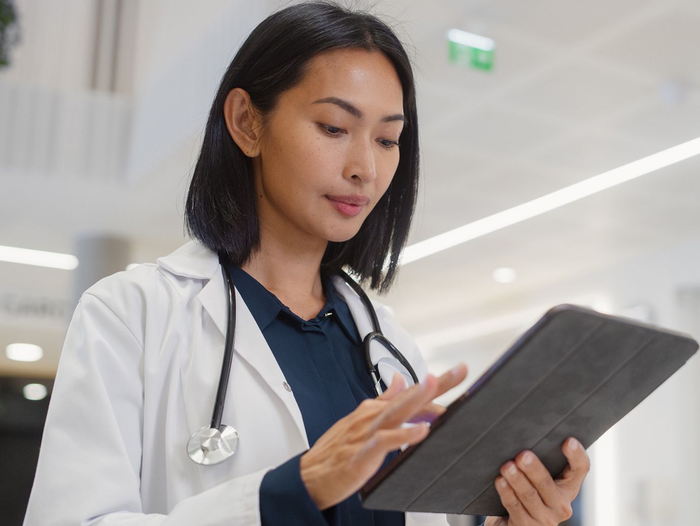 Female doctor looking at tablet