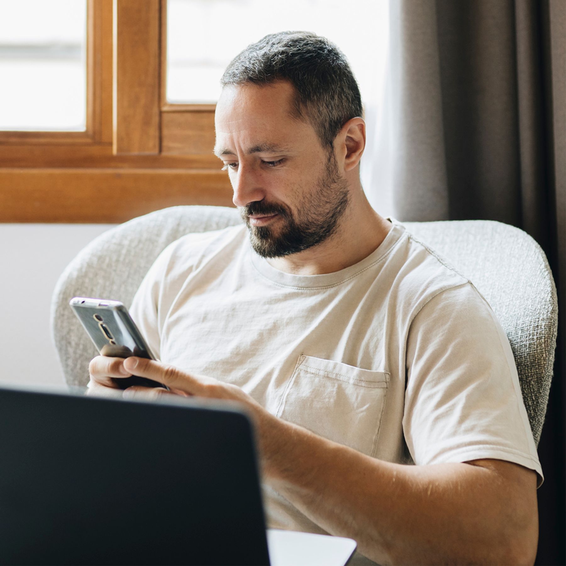 Rightway | Clinical Care Navigation | Effective Transparent PBM.. Man sitting in chair looking at phone