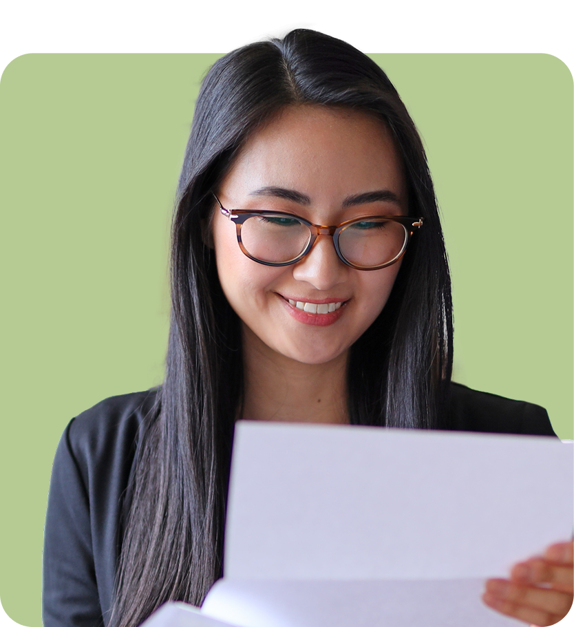 lady smiling with glasses reading a document