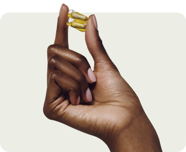 Hand holding yellow pills
