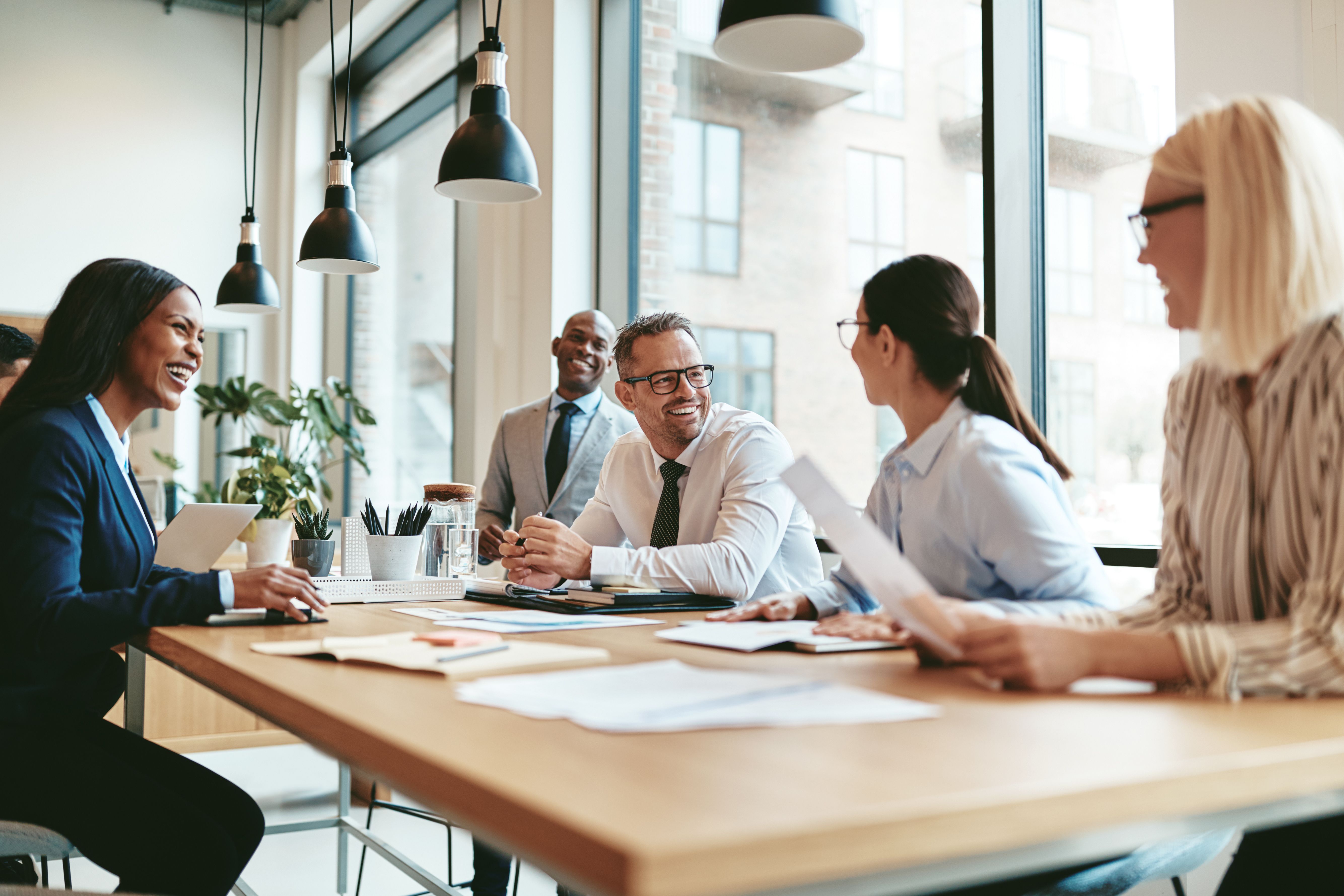 coworkers sitting around table talking