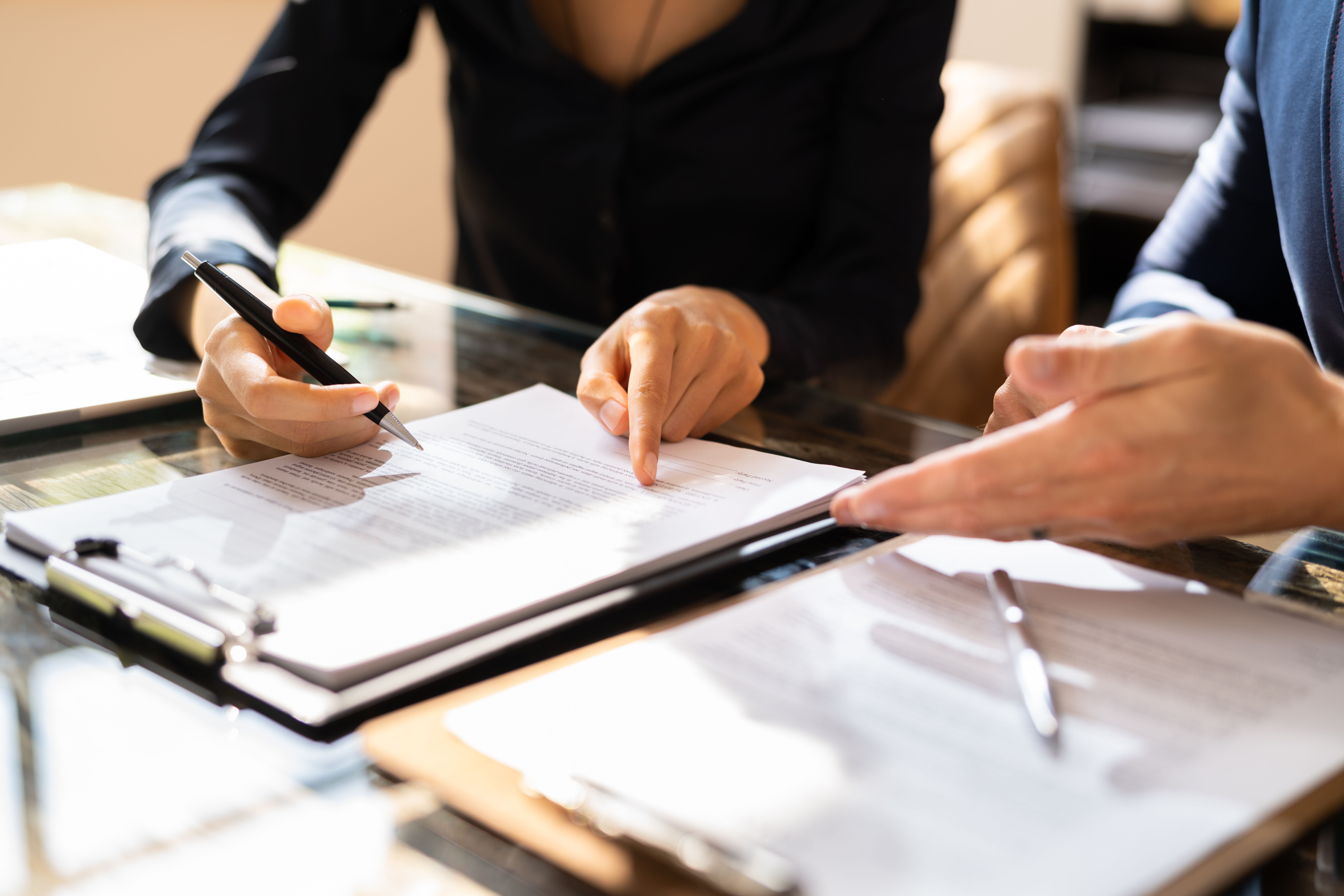 Two Businesspeople Working on Contract Paper