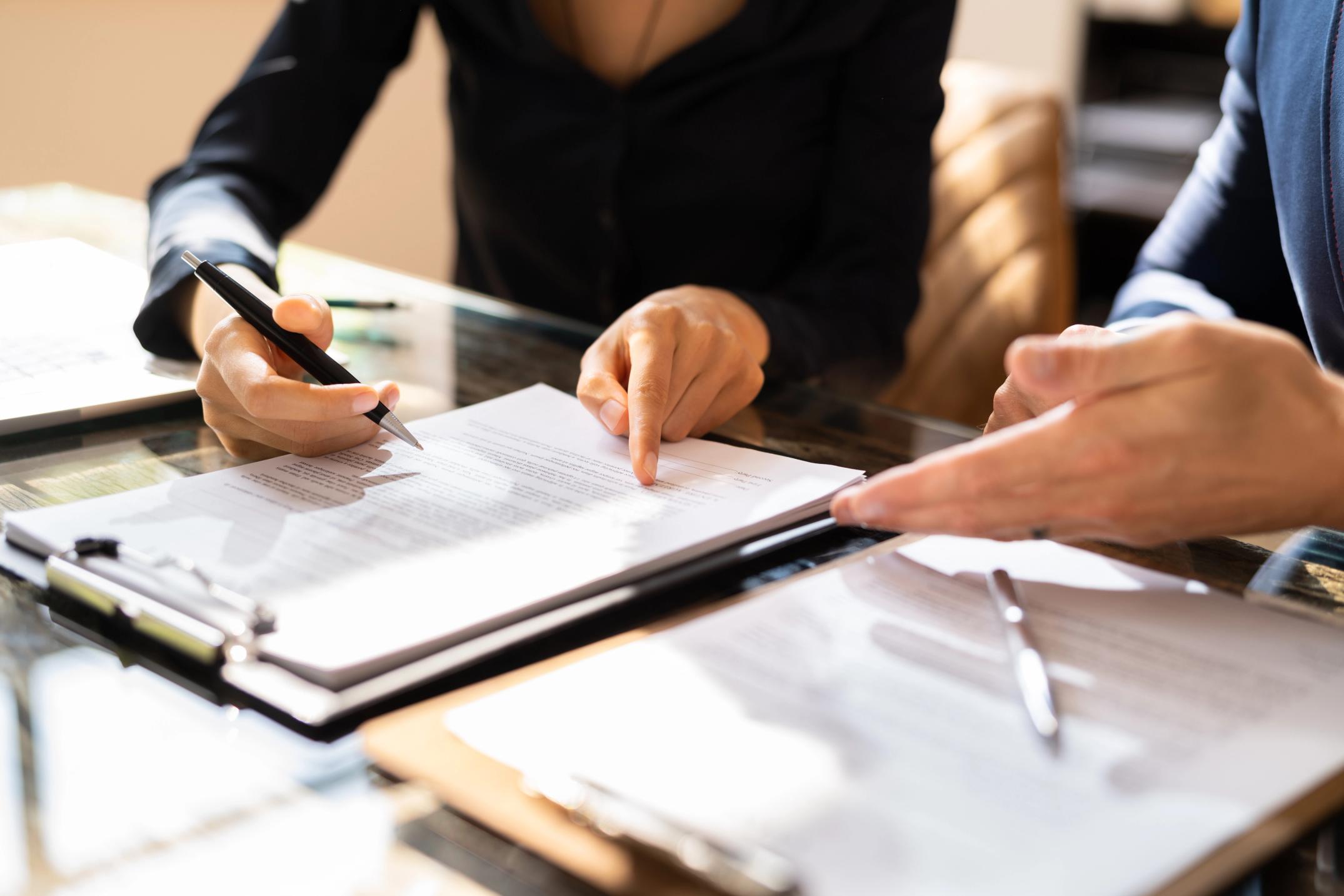 Two Businesspeople Working on Contract Paper