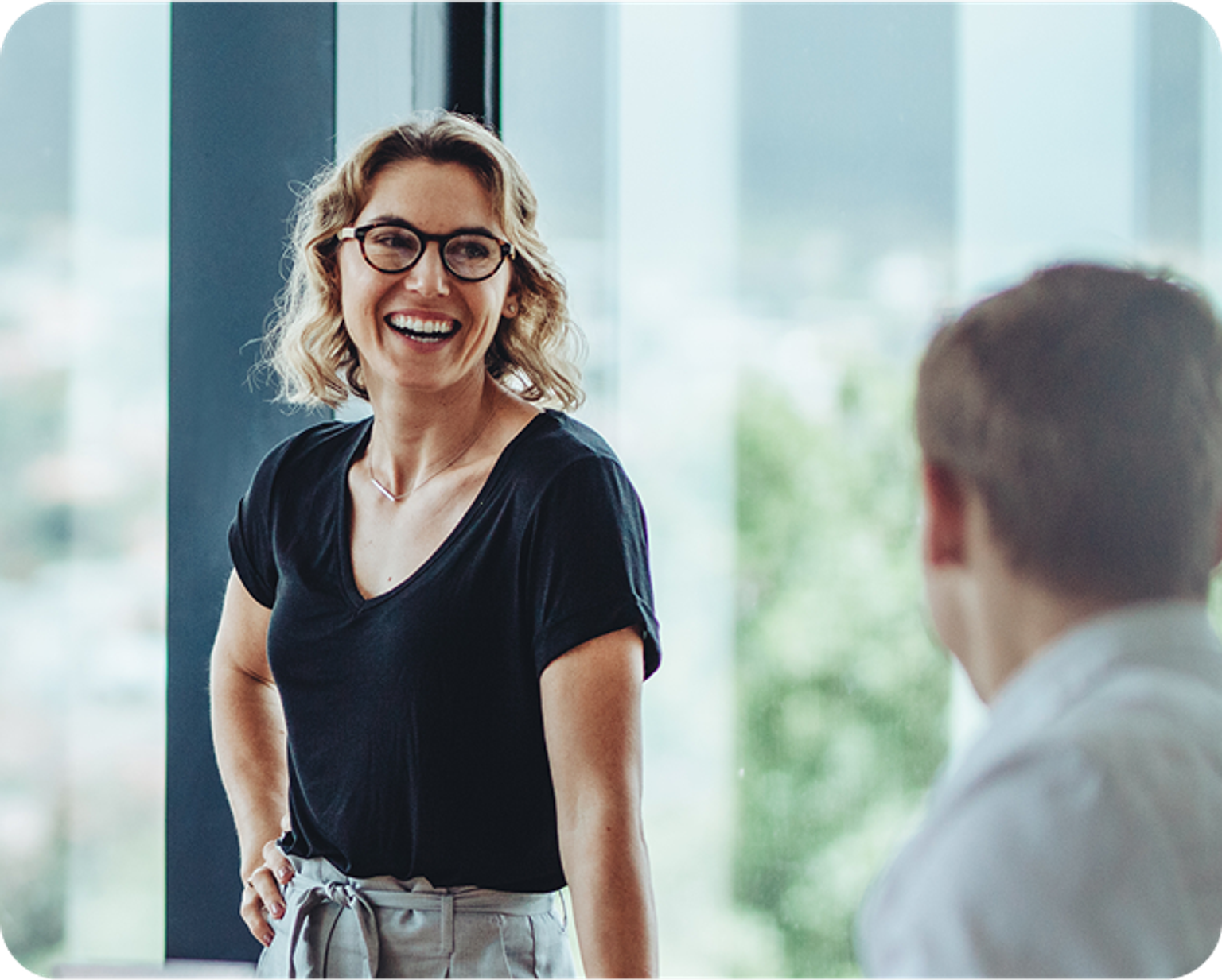 group of people laughing in a meeting