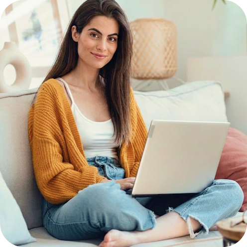 Lady with laptop sitting on sofa
